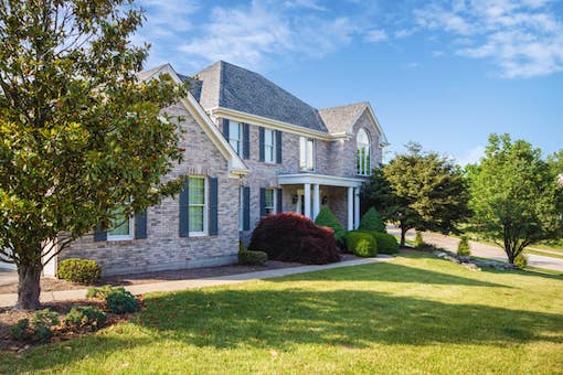 An image of large two story house with lawn in front of it.Sarasota Management & Leasing can provide property management for a property like this